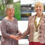 Photo of Noreen collecting a donation from Knighton Rotary Club